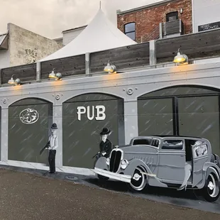 an old car parked in front of the pub