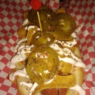 Porky Dawg..smoked sausage with homemade chili, chopped brisket, fritos, sour cream, gords sauce, cheese sauce, n jalapeños
