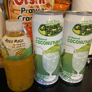 three cans of green tea and coconut water