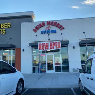 two cars parked in front of the store