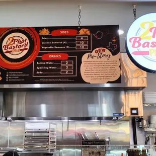 Menu and sign, side view of shop