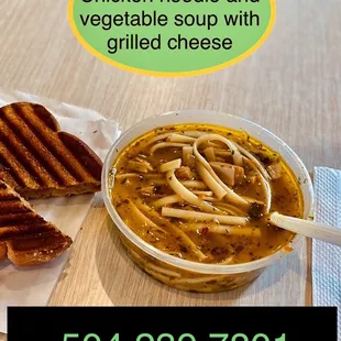 a bowl of soup and a grilled cheese sandwich