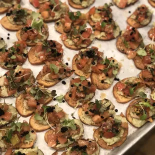 Tomato bruschetta with an Avocado Schmeer topped with balsamic caviar
