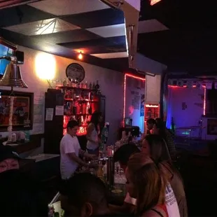 a group of people sitting at a bar