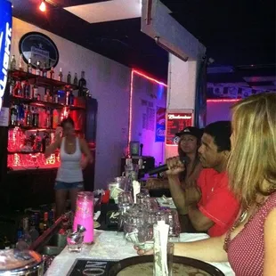 a group of people sitting at a bar