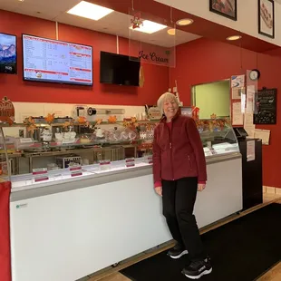 a woman standing in front of the counter
