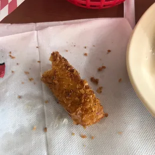  half eaten piece of fried fish