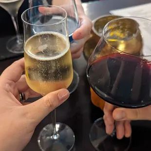 two people holding glasses of wine