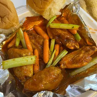 a plate of chicken wings and carrots