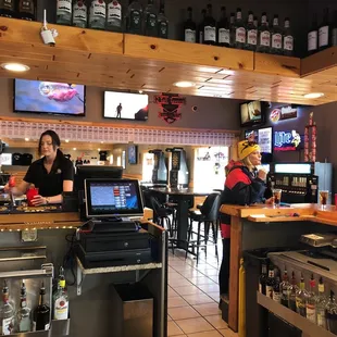 a bar with people sitting at the bar