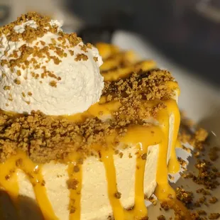 a slice of cheesecake with caramel drizzle