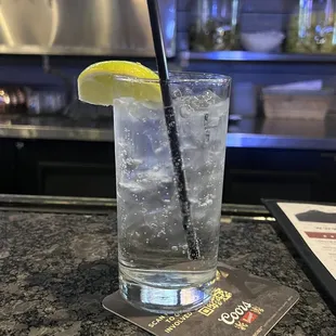 a glass of water with a lemon wedge