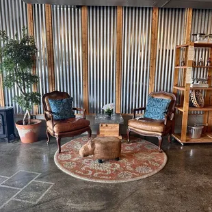 a living area with chairs and a table