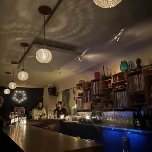 a bar with people sitting at the bar