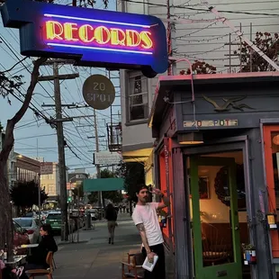a man standing in front of a restaurant
