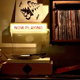 "NOW PLAYING"  Great live vinyl spinning in the background)