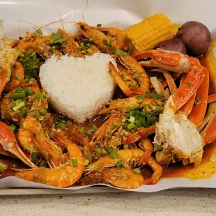 Snow crab and shrimp platter. Super fresh and good quality seafood.  Also includes red boiled potato, rice and corn