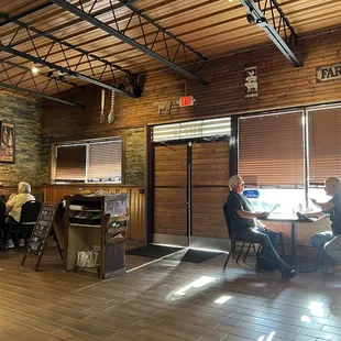 people sitting at tables in a restaurant