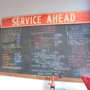 Giant chalkboard menu by the front til.