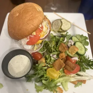 Cheese burger with a side salad with homemade ranch dressing