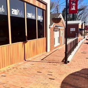 a brick sidewalk in front of a building