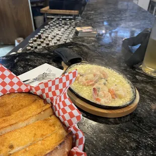 Sizzling shrimp and garlic bread. Unique and delicious!