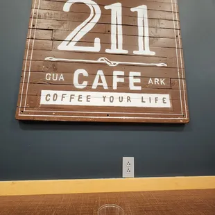 a cup of coffee in front of a sign