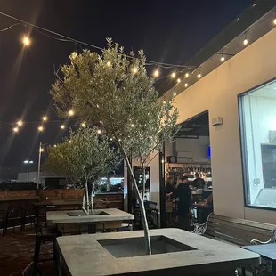 Patio seating with a view of the pizza crew