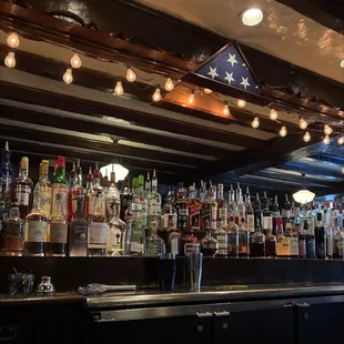 a row of liquor bottles on a bar