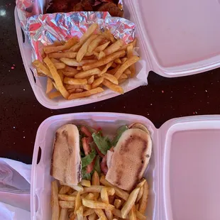 two trays of french fries and a sandwich