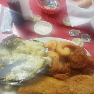 Combination Shrimp, Scallops, and Trout with a baked potato, hush puppies, and Cole slaw.