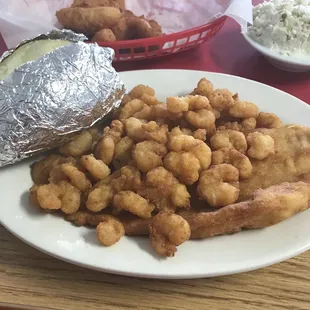 Popcorn shrimp and fried fish with a baked potato. Enough food for 2-3 servings.