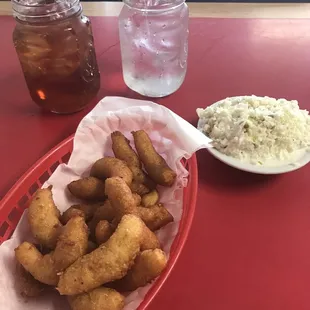 Hush puppies, coleslaw, and your drinks are served once you order.