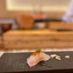 a sushi dish on a slate plate