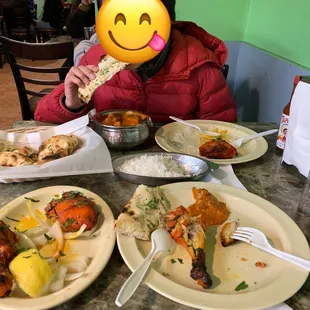 91. Tandoori Chicken, Garlic Naan, and 118. Lamb Tikka Masala (mild).