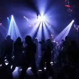 a crowd of people dancing at a nightclub