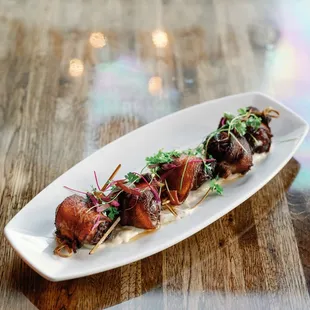 Bacon wrapped dates stuffed with blue cheese, served with dijon aioli
