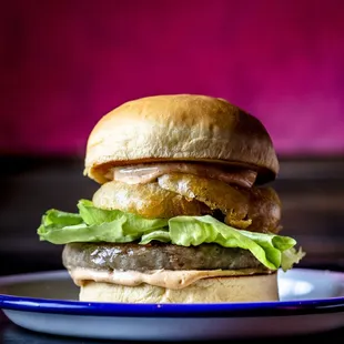 a hamburger on a plate with lettuce