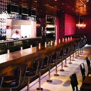 a restaurant with a bar and chairs
