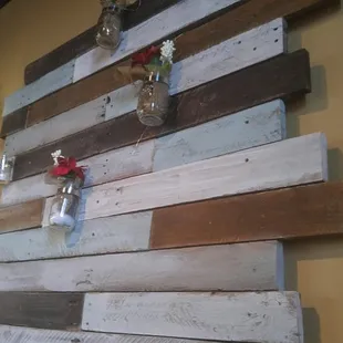 a wooden wall decorated with mason jars