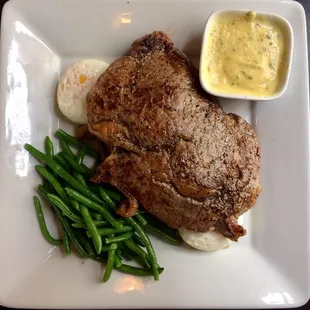Grilled ribeye with béarnaise, poached egg, roasted fingerling potatoes, and green beans