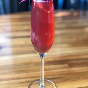 a red drink in a wine glass