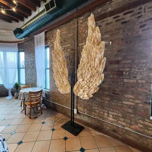 a brick wall with two wings on it