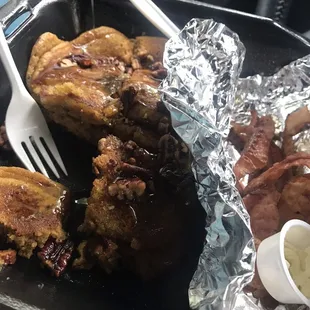 Butter Pecan pancakes with syrup and side of bacon