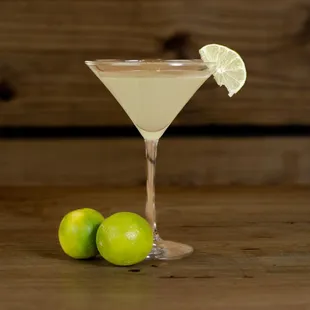 a martini with a lime garnish