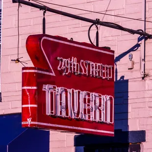 a red sign hanging from the side of a building