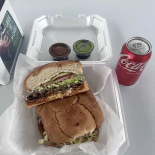 a sandwich and a can of soda