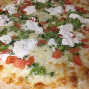 Our White Pizza, made with a Garlic and Olive Oil Sauce, Fresh Diced Tomatoes, Broccoli, Mozzarella Cheese and Ricotta Cheese.
