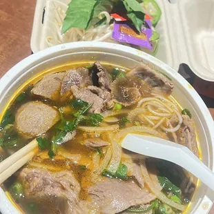 a bowl of soup with meat and vegetables