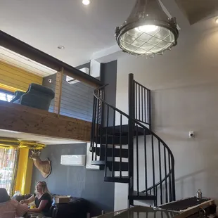 a spiral staircase leading to the second floor